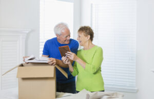 Senior couple packing a box together