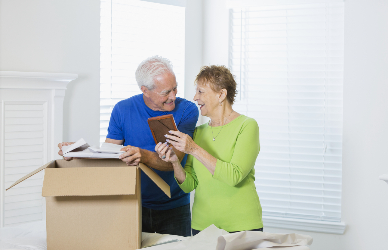 Senior couple packing a box together