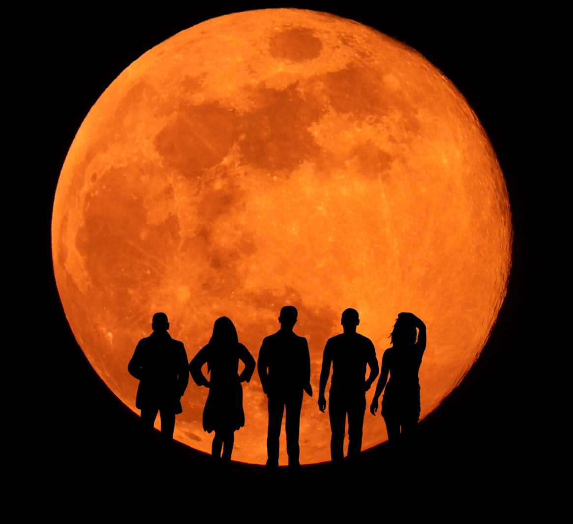 people shadows in front of eclipsed moon